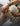 Person holding a jar of CBD balm with green nails, showcasing the soothing benefits of hemp-derived products.
