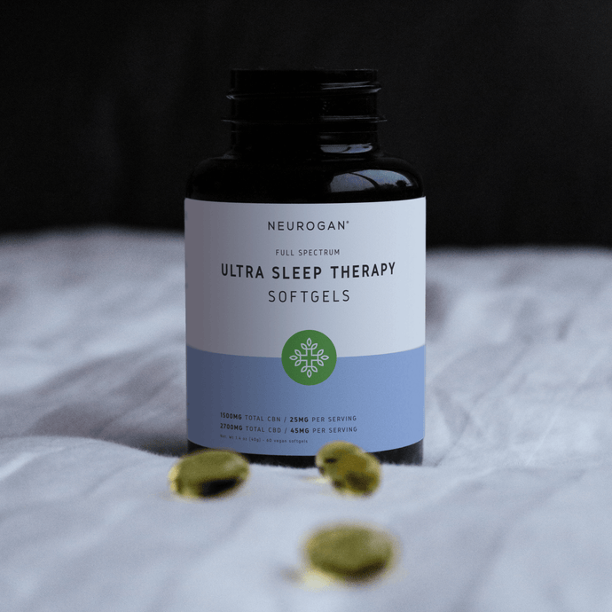 Ultra Sleep Therapy softgels laying on bed with white sheet