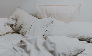 Messy white bed and pillows 