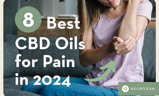 Holding elbow in pain looking at best CBD oils for pain in 2024