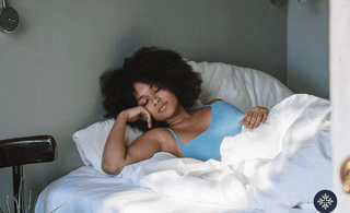 A woman sleeping comfortably. CBD vs. Melatonin for Sleep | Which One to Choose?