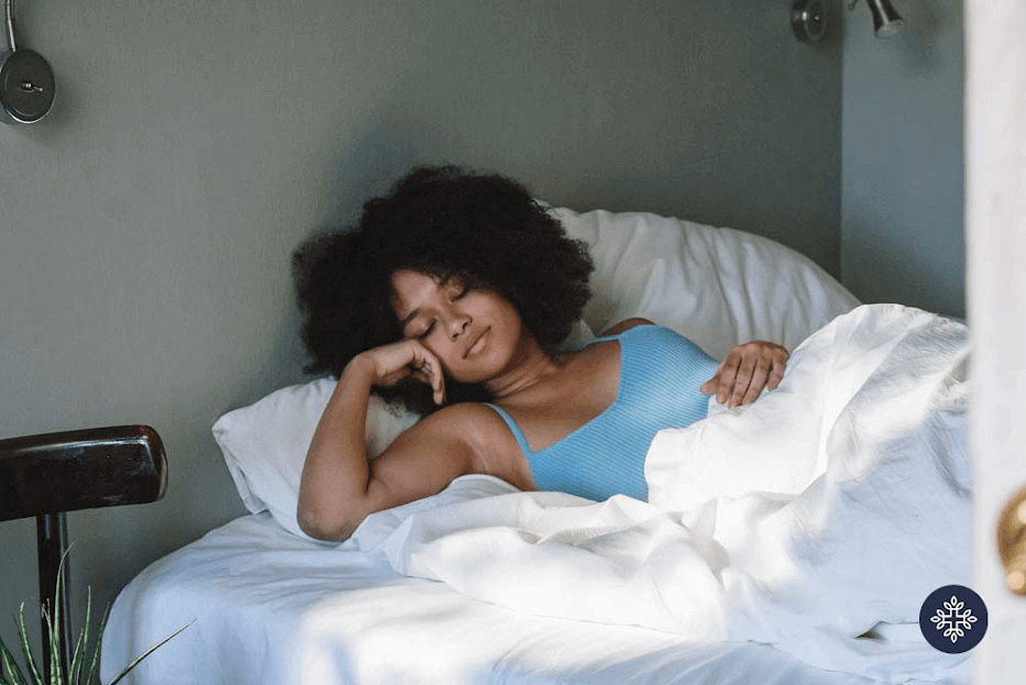 A woman sleeping comfortably. CBD vs. Melatonin for Sleep | Which One to Choose?