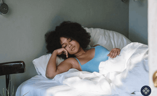 A woman sleeping comfortably. CBD vs. Melatonin for Sleep | Which One to Choose?