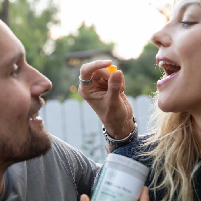 Couple tasting CBD Live Resin mango gummy