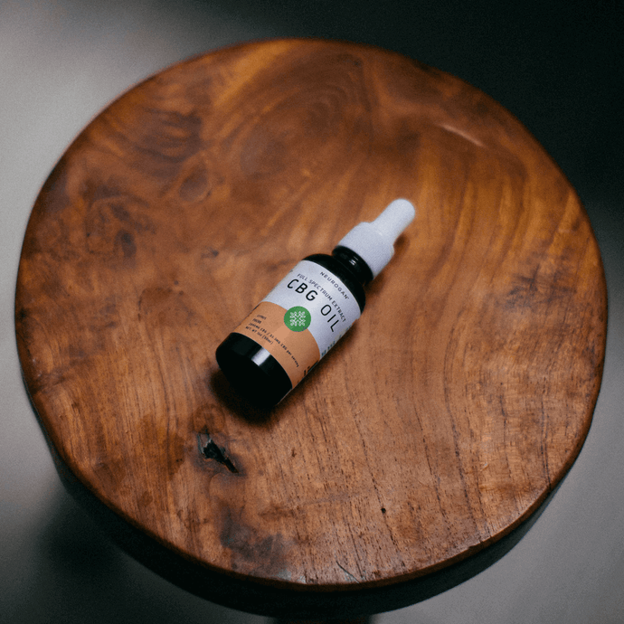 CBG Focus Oil 2000mg bottle on a wooden round table
