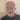 Man with gray beard discussing CBD benefits in a casual setting, sharing insights on wellness.