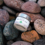 Neurogan CBD Cooling Rub on river rocks of various cool-colored tones