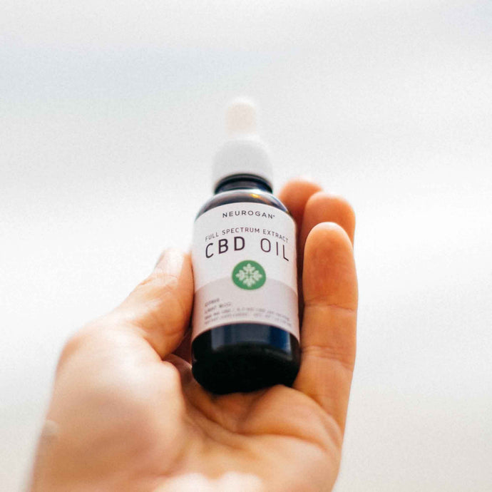 Close up of a CBD oil 1000mg bottle hand held.